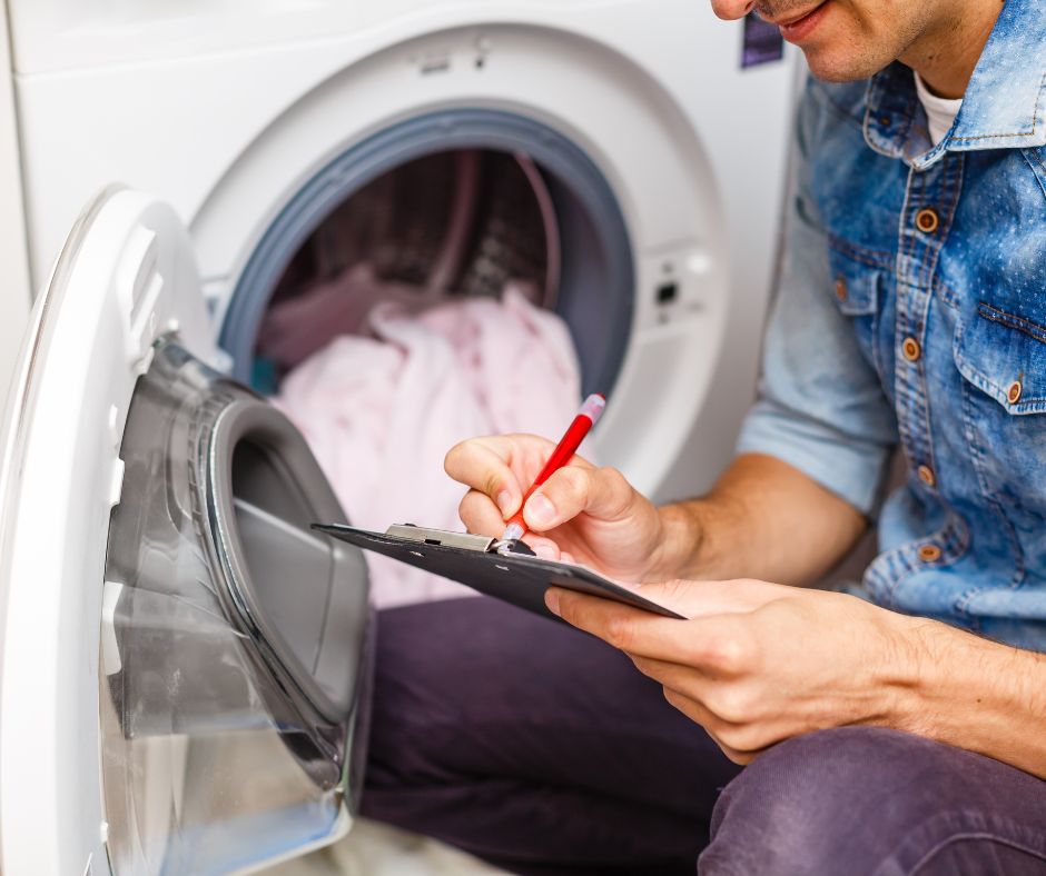 Dryer machine with back panel open during repair service in Dubai