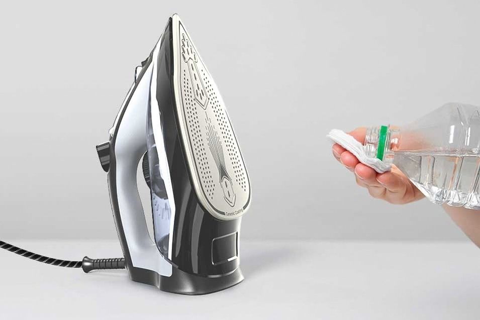 Pouring water into steam iron for maintenance in Dubai. Common Electric Iron problems and Repairs in Dubai.