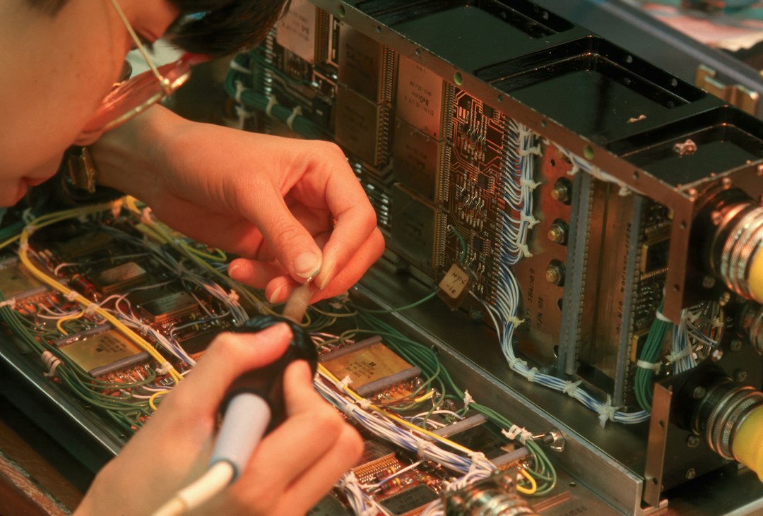 Expert working on electronic circuitry and wires for home electronics repair in Dubai